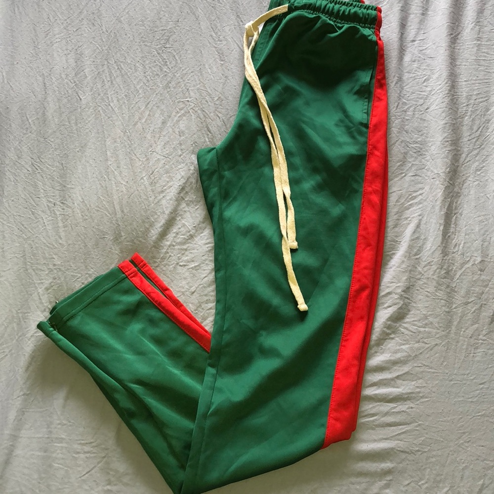 Green  track pants with red stripes on sides